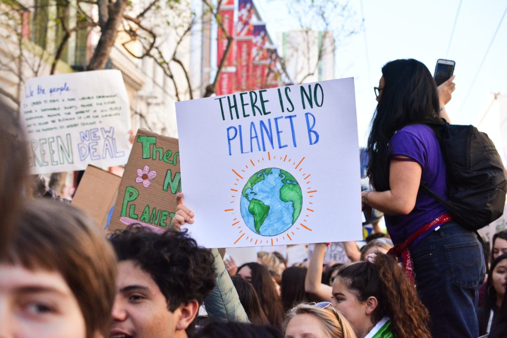 Young people demonstrating with placards saying "There is no Planet B"