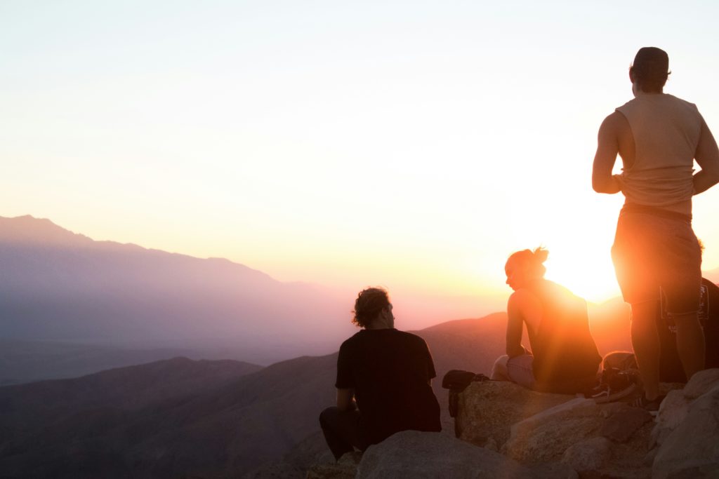 Sunrise, with several people silhouetted againt the rising sun