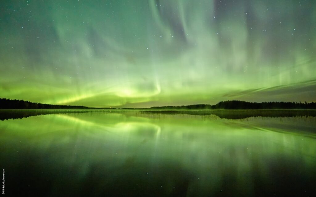A beautiful green aurora borealis over a northern sea