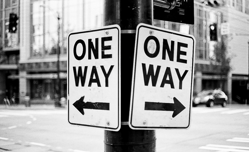 Two contradictory One Way signs pointing left and right