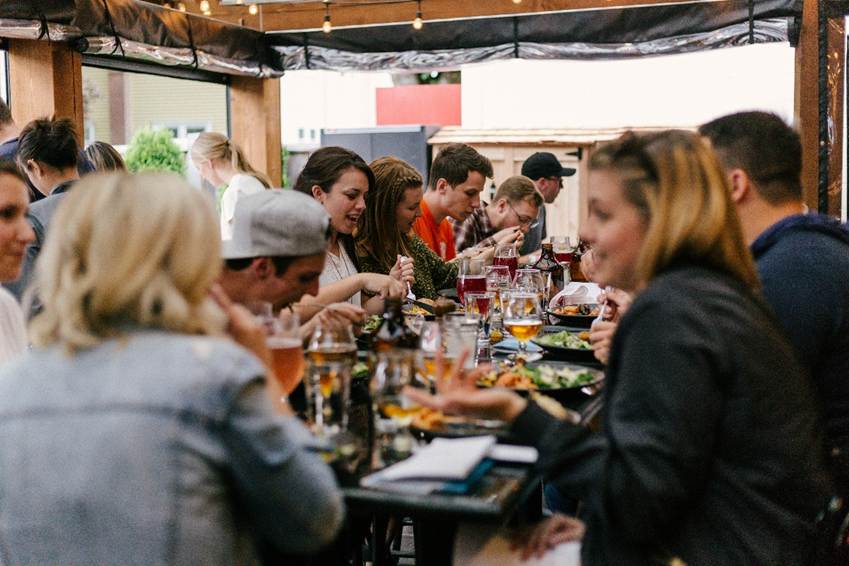 A large group of people enjoying a meal together