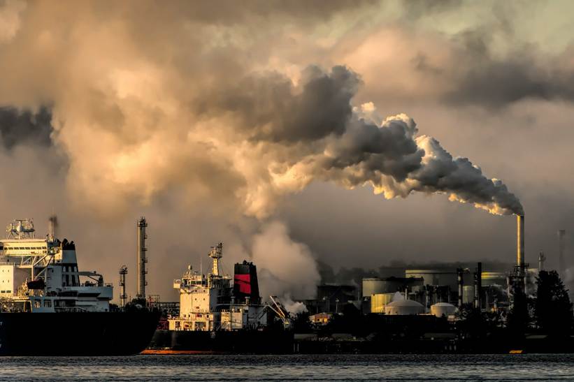 Fumes belching out of a factory, polluting the sky