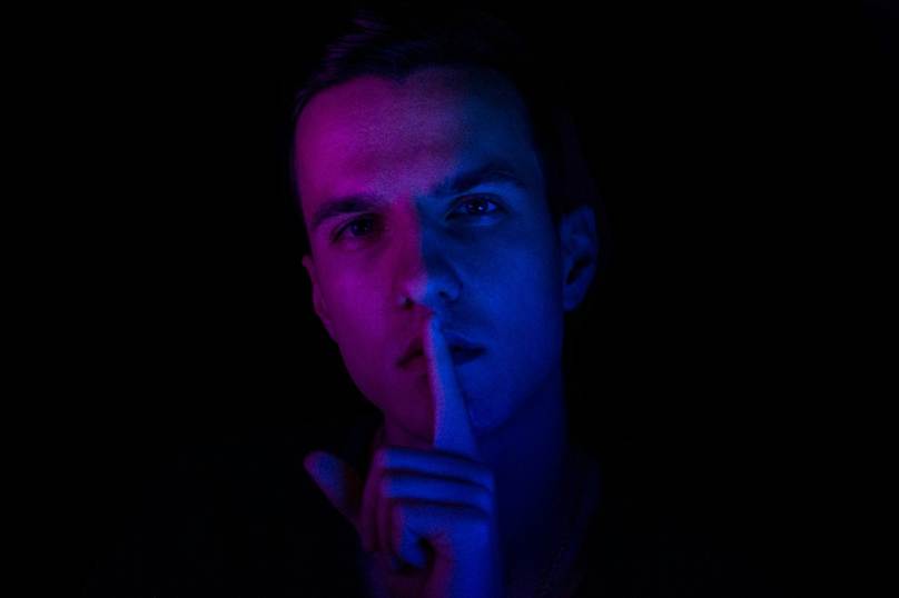 A person with their finger on their lips