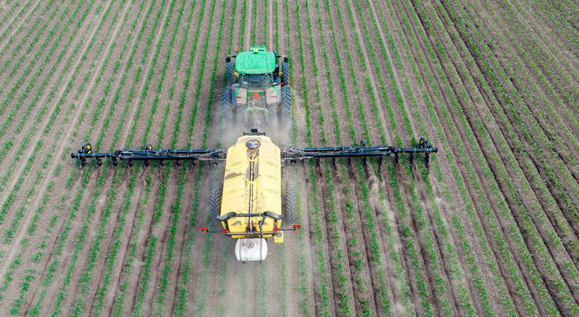 A tractor spraying pesticides