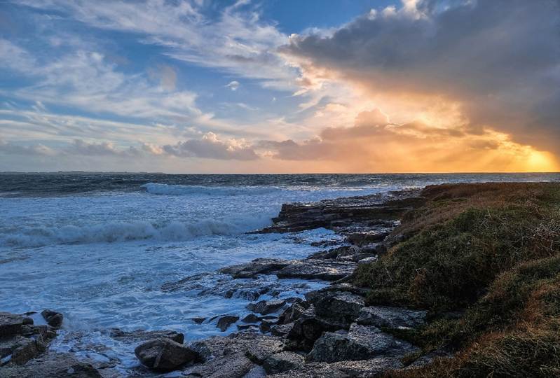The sun setting over a beautiful sea coast